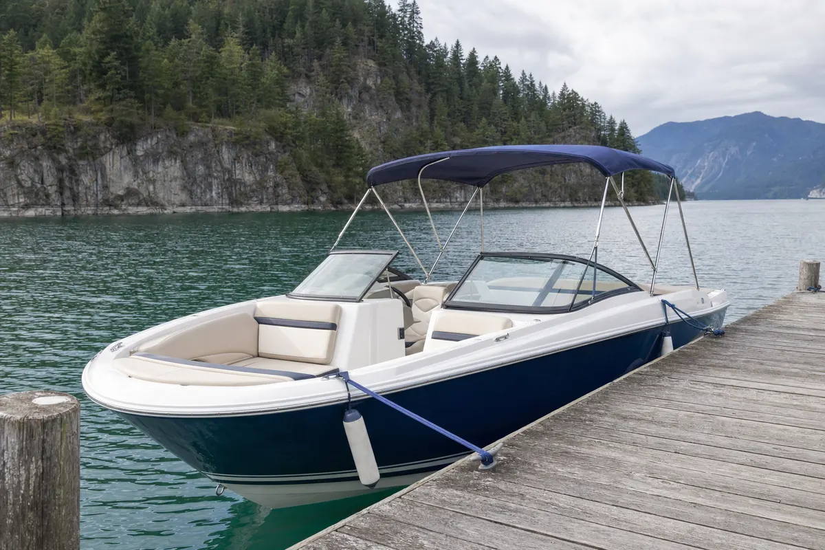 Bow rider boat tied up at a lake dock